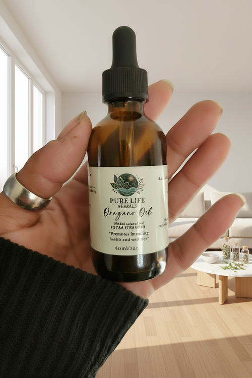 Hand holding a bottle of Pure Life Oregano Oil with a dropper on a plain background
